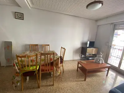 a living room with a dining room table and chairs at FLAT FAMILY NEAR BEACH GARDEN CENTER AND METRO in Valencia