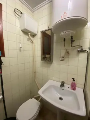 a bathroom with a white sink and a toilet at FLAT FAMILY NEAR BEACH GARDEN CENTER AND METRO in Valencia