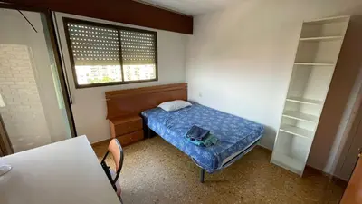 a small bedroom with a bed and a window at flat Holiday friend group or family near beach center blasco ibanez in Valencia