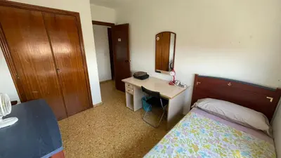 a bedroom with a bed and a desk with a mirror at flat Holiday friend group or family near beach center blasco ibanez in Valencia