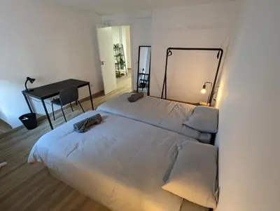 a bedroom with a bed and a desk and a table at Entre montañas in Dos Aguas