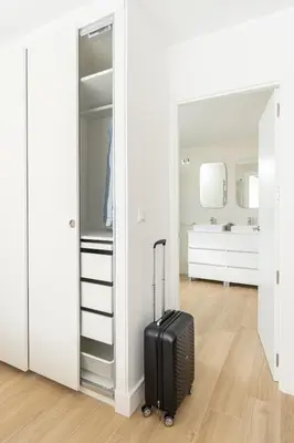 a black suitcase in a room with a mirror at Espectacular piso reformado al lado del rio Turia in Valencia