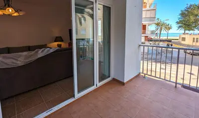a balcony with a couch and a view of the ocean at Terraza con vistas al mar Parking privado 120 mts, junto a la playa in Cullera