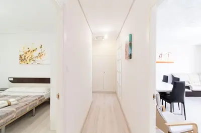 a room with two beds and a dining room at Global Vacacional, Apartamento de 4 habitaciones a 100 m de la playa in Puerto de Sagunto