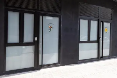 three glass doors on a black building with flowers on them at FLORIT FLATS - The Green Apartments in Valencia