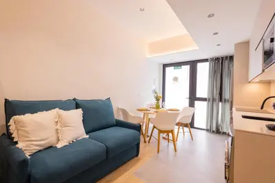 a living room with a blue couch and a table at FLORIT FLATS - The Green Apartments in Valencia