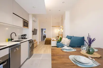 a kitchen and living room with a table in a room at FLORIT FLATS - The Green Apartments in Valencia