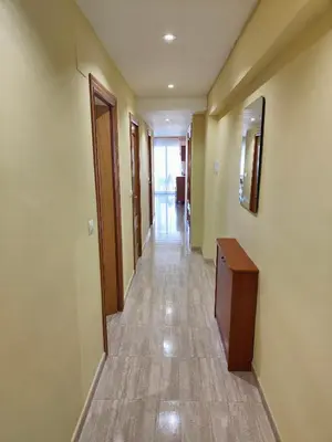 a hallway of a hospital with a door and a table at Sea view apartment in Cullera