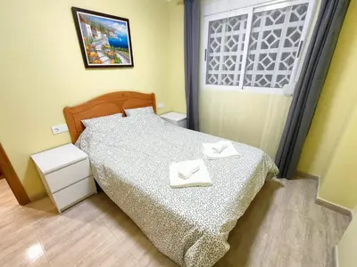 a bedroom with a bed with two white towels on it at Sea view apartment in Cullera