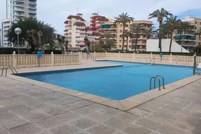 a large swimming pool in a city with buildings at Playa Puebla de Farnals Valencia in Masalfasar