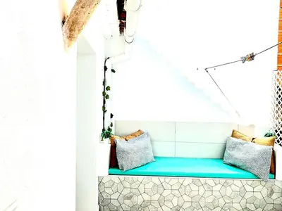 a room with two pillows on a blue bench at Loft B El Ramellet in Alginet