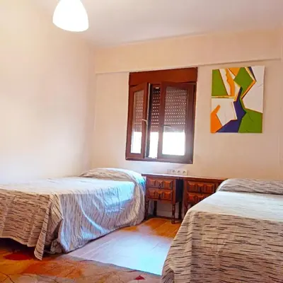 a bedroom with two beds and a window at Vistas a las palmeras in Burjasot