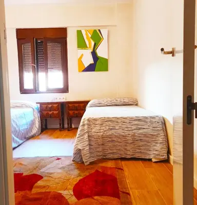 a bedroom with two beds and a window at Vistas a las palmeras in Burjasot