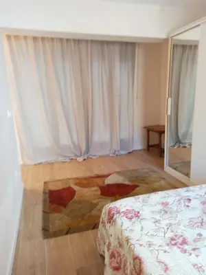 a bedroom with a bed and a large window at Vistas a las palmeras in Burjasot