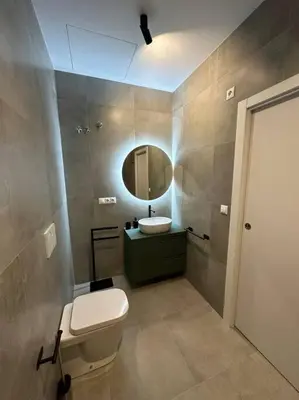 a bathroom with a toilet and a sink and a mirror at Industrial Style Ruzafa in Valencia