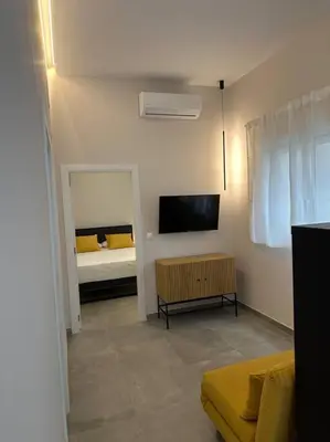 a living room with a bed and a television at Industrial Style Ruzafa in Valencia