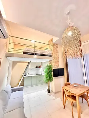 a living room with a couch and a table at Bali style Ruzafa in Valencia