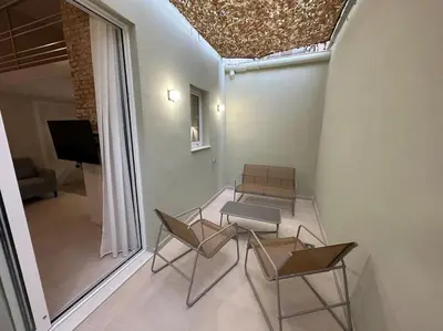 a room with chairs and a table and a tv at Bali style Ruzafa in Valencia