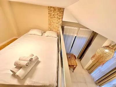 a room with a bed with towels on it at Bali style Ruzafa in Valencia